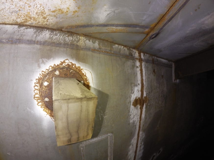 Detail of foam filling port high up on the internal tank wall.