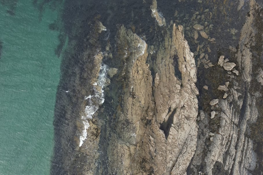 A typical view form the drone on this coastal mapping project showing a rocky coastline and the sea next to it. Note the amount of detail that shows through the water.