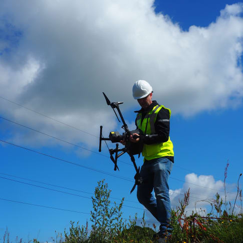 A drone operator carrying a drone