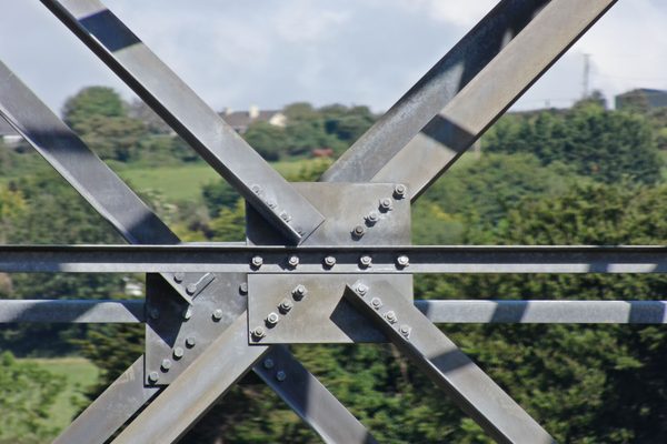 A detailed shot of the steel lattice work of a large communications tower