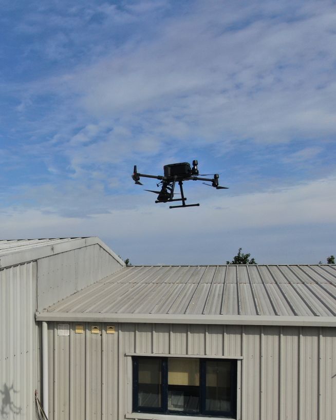 A drone performing a roof inspection