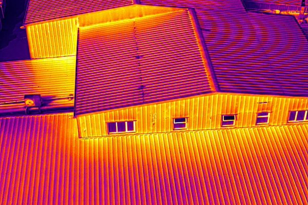 A thermal image of a commercial building captured by a drone during a roof survey