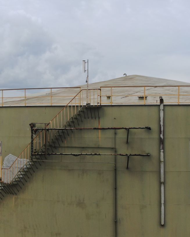 A photo of a storage tank being inspected by a drone