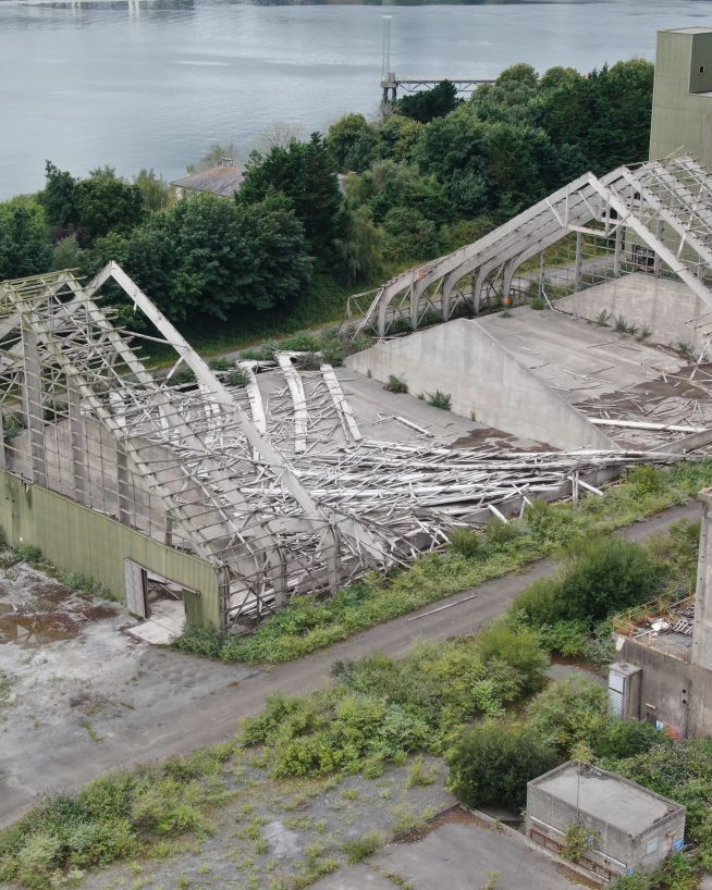 An image of a storm-damaged building and roof taken by a drone during a storm damage inspection.
