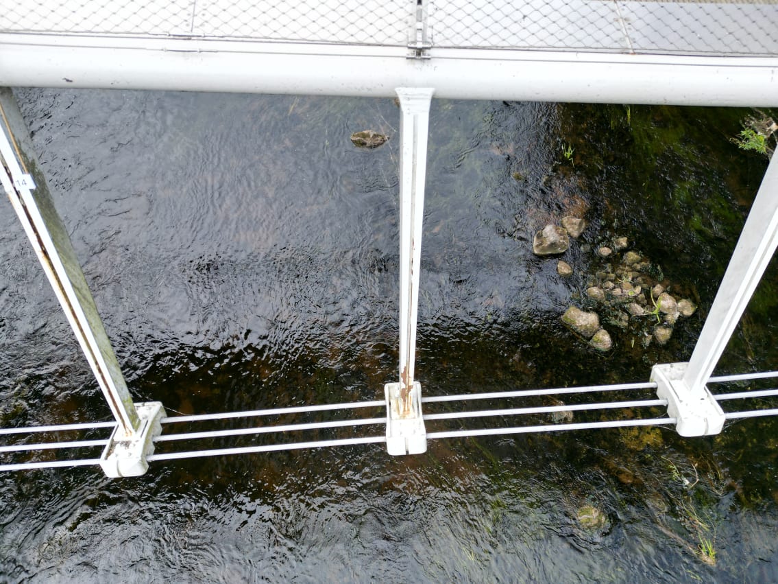 A view of the cable arms and shoes showing some corroded areas where the surface finish has failed.