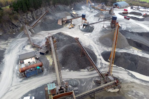 An elevated view of a quarry plant with stockpiles of different materials
