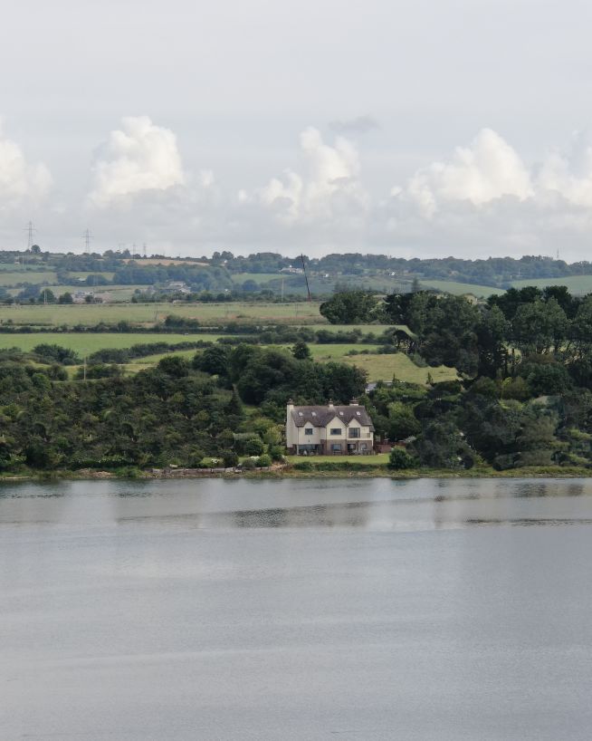 A house next to a river taken by a drone performing drone real estate services