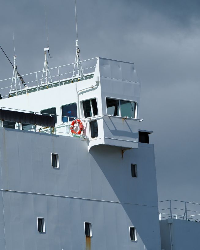 A photo of a ship being inspected by a drone