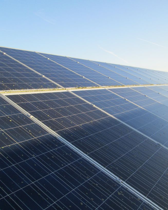 Solar panels being inspected by a drone