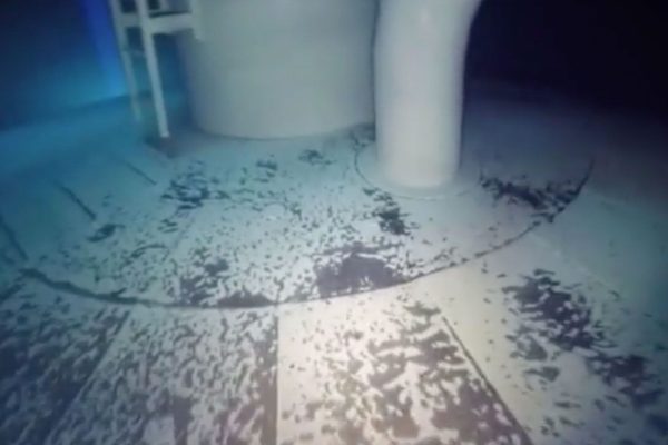 An underwater ROV inspecting the interior of a water tank while it remains full
